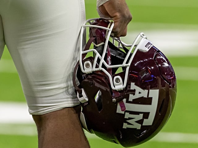 HOUSTON, TX - DECEMBER 27: Texas A&M Aggies helmet is held before the TaxAct Texas Bowl between Texas A&M Aggies and Oklahoma State Cowboys on December 27, 2023, at NRG Stadium in Houston, Texas. (Photo by David Buono/Icon Sportswire via Getty Images)