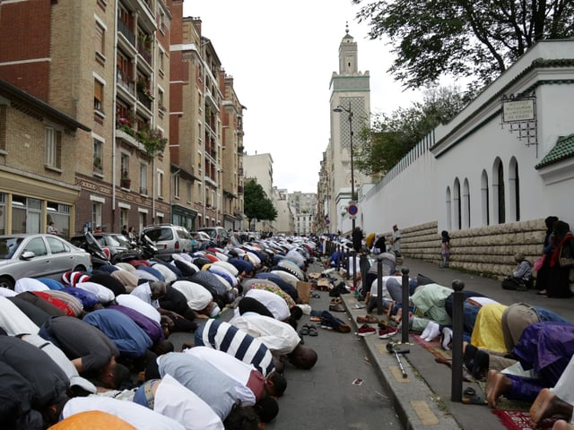 Muslims offer Eid al-Fitr prayers outside the Grande Mosquee de Paris (Great Mosque of Paris) in Paris on June 25, 2017. Eid al-Fitr festival marks the end of the holy Muslim fasting month of Ramadan during which devotees are required to abstain from food, drink and sex from dawn to dusk. / AFP PHOTO / Zakaria ABDELKAFI (Photo credit should read ZAKARIA ABDELKAFI/AFP via Getty Images)