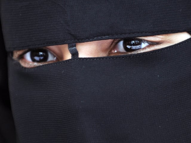 A Muslim woman wearing the niqab (veil which covers the body and leaves only a small strip for the eyes) is pictured during a meeting with Imam Ali El Moujahed on May 18, 2010 in Montreuil, outside Paris. The French parliament unanimously adopted on May 11, 2010 a resolution condemning the full-face Islamic veil as an affront to the nation's values. AFP PHOTO FRED DUFOUR (Photo by Fred DUFOUR / AFP) (Photo by FRED DUFOUR/AFP via Getty Images)
