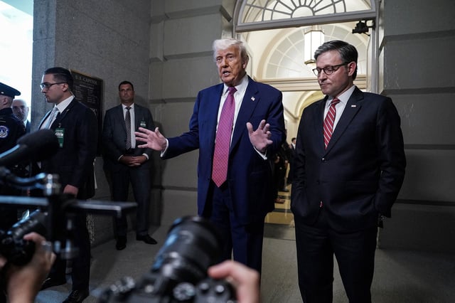 President Donald Trump gestures next to House Speaker Mike Johnson on Capitol Hill in Washington, DC, on May 20.
