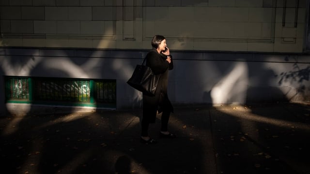 A woman talks on her cellphone in downtown Vancouver. B.C. is getting a new 257 area code this weekend. It will join the existing codes throughout the province and will have no impact on existing phone numbers. 