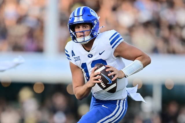 Jake Retzlaff #12 of the Brigham Young Cougars rushes the ball in the third quarter against the UCF Knights at FBC Mortgage Stadium on October 26, 2024 in Orlando, Florida. (Photo by Julio Aguilar/Getty Images)
