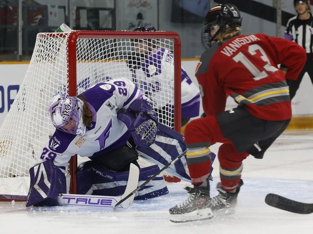 Ottawa's Tereza Vanišová tries to get the puck past Minnesota goaltender Nicole Hensley during first-period action on Tuesday.