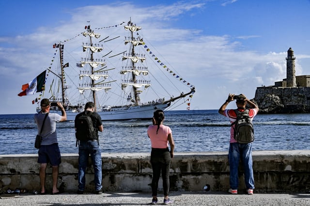 People take pictures at the Mexican Navy training sail ship &#34;Cuauhtemoc&#34; while docking at Havana Harbor on April 28, 2025. (Photo by YAMIL LAGE / AFP) (Photo by YAMIL LAGE/AFP via Getty Images)