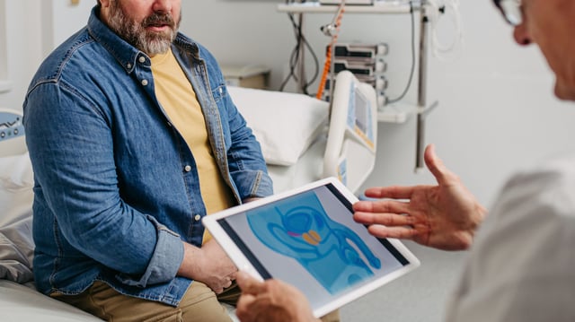 Doctor explaining prostate examination to male patient during routine check-up. Men’s health care.