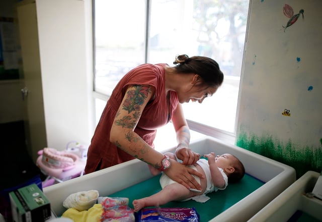 Vanessa Moreno, 24, changes the diapers of her two-month-old baby Makayla at Prototypes residential treatment program in Pomona, California, March 26, 2013. Prototypes is part of the Second Chance Women's Re-entry Court program, one of the first in the U.S. to focus on women. It offers a cost-saving alternative to prison for women who plead guilty to non-violent crimes and volunteer for treatment. Of the 297 women who have been through the court since 2007, 100 have graduated, and only 35 have been returned to state prison. Picture taken March 26, 2013. REUTERS/Lucy Nicholson (UNITED STATES - Tags: SOCIETY CRIME LAW TPX IMAGES OF THE DAY)