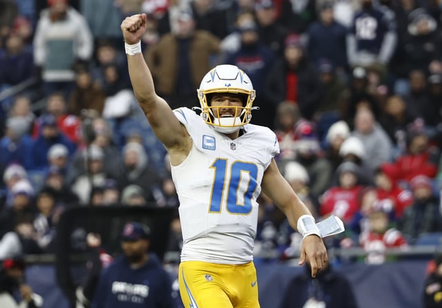 Justin Herbert #10 of the Los Angeles Chargers celebrates after a touchdown during the fourth quarter against the New England Patriots at Gillette Stadium on December 28, 2024 in Foxborough, Massachusetts.