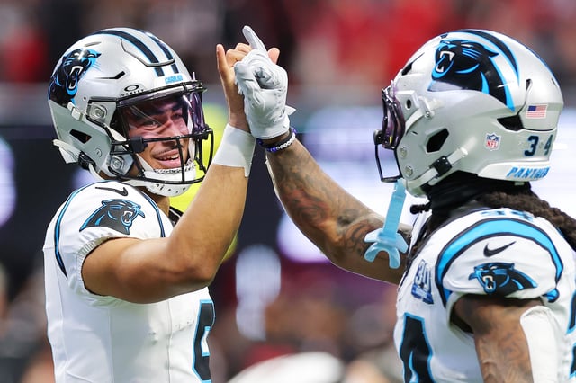Bryce Young #9 of the Carolina Panthers celebrates with teammate Mike Boone #34 after scoring a touchdown against the Atlanta Falcons during the second quarter at Mercedes-Benz Stadium on January 05, 2025 in Atlanta, Georgia.