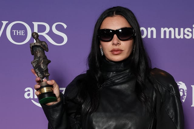 Charli XCX poses for a portrait holding her Songwriter of the Year with Amazon Music award at the Ivor Novello Awards in London, Britain, May 22, 2025. REUTERS/Toby Melville