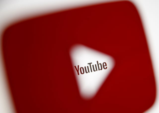 A 3D-printed YouTube icon is seen in front of a displayed YouTube logo in this illustration taken October 25, 2017. REUTERS/Dado Ruvic/Ilustration/File Photo