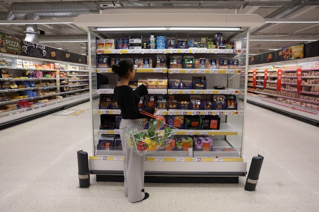 A customer shops in the fish aisle inside a Sainsbury?s supermarket, in Richmond, West London, Britain February 21, 2024. REUTERS/Isabel Infantes/File Photo