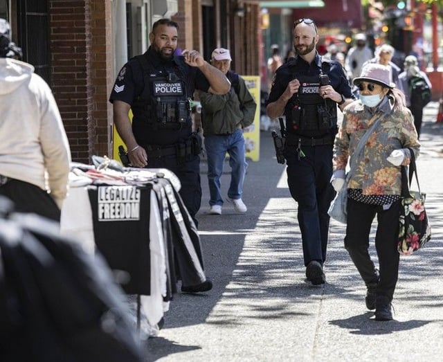  Two Vancouver police officers on foot patrol in the Downtown Eastside on Thursday.