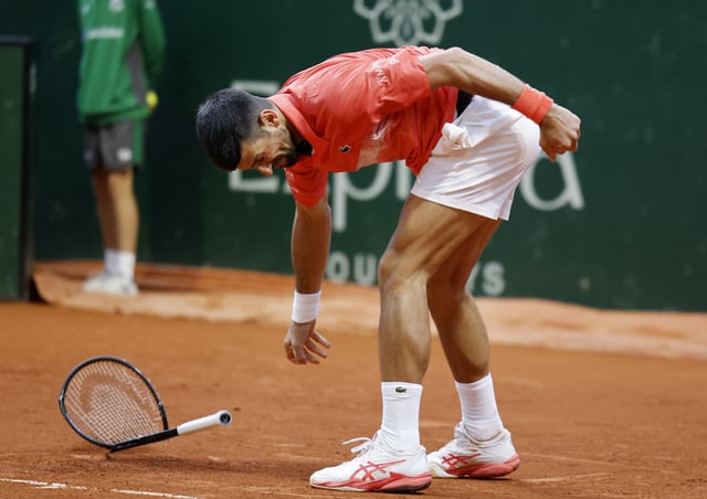 Tennis - Geneva Open - Tennis Club de Geneve, Geneva, Switzerland - May 22, 2025 Serbia's Novak Djokovic smashes his racket during his quarter final match against Italy's Matteo Arnaldi REUTERS/Stefan Wermuth