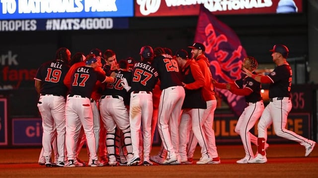 May 22, 2025; Washington, District of Columbia, USA; Washington Nationals third base Amed Rosario (13) is mobbed by teammates after hitting a walk off single against the Atlanta Braves during the tenth inning at Nationals Park. Mandatory Credit: Brad Mills-Imagn Images