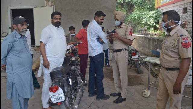 Police collecting information from the deceased’s kin in Sanyas Nagar in Ludhiana on Thursday. (Gurpreet Singh/HT)