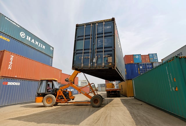 A mobile crane carries a container at Thar Dry Port in Sanand in the western state of Gujarat, India, February 13, 2017. Picture taken February 13, 2017. REUTERS/Amit Dave/File Photo
