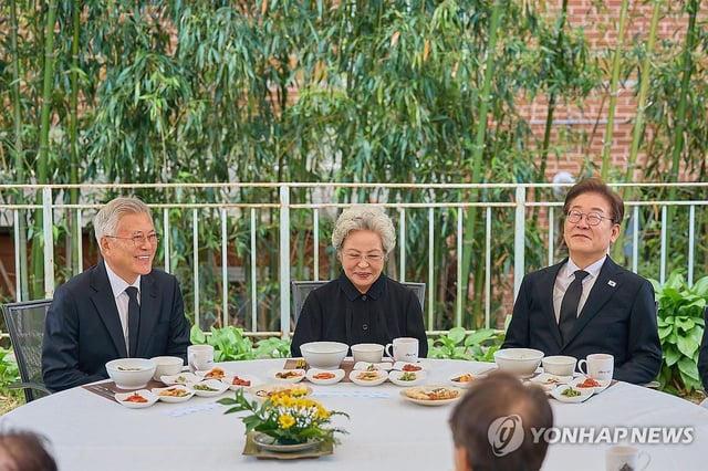 Democratic Party presidential candidate Lee Jae-myung (R) holds a luncheon meeting with former President Moon Jae-in (L) and Kwon Yang-sook, former President Roh Moo-hyun's widow, in the rural village of Bongha in Gimhae, southeastern South Korea, on May 23, 2025, in this photo provided by Lee's party. (PHOTO NOT FOR SALE) (Yonhap)