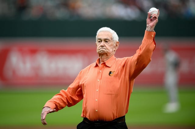 Jim Henneman throws out a ceremonial first pitch before a baseball game between the Baltimore Orioles and the Oakland Athletics, Saturday, April 27, 2024, in Baltimore. (AP Photo/Nick Wass)