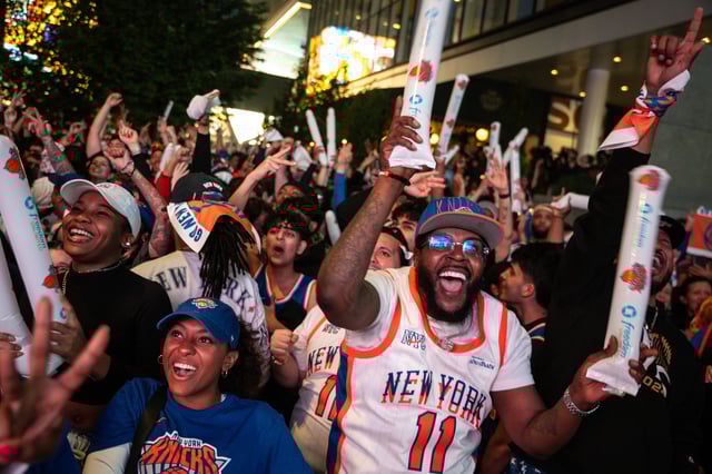 NEW YORK, NEW YORK - MAY 16: New York Knicks fans cheer for a three-pointer in the first quarter of Game Six of the Eastern Conference Second Round NBA Playoffs against the Boston Celtics at a watch party hosted by the Knicks outside of Madison Square Garden on May 16, 2025 in New York City. (