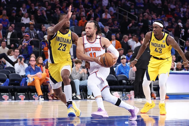 New York Knicks guard Jalen Brunson (11) drives against Indiana Pacers forward Aaron Nesmith (23) during Game 1 of the Eastern Conference finals in the 2025 NBA Playoffs.