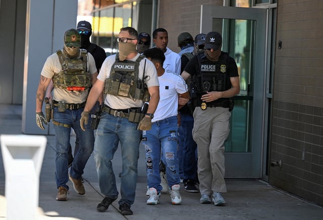 Law enforcement officers, including HSI and ICE agents, take people into custody at an immigration court in Phoenix, Arizona, U.S., May 21, 2025.  REUTERS/Caitlin O'Hara/File Photo