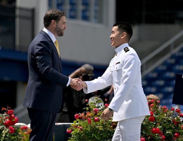 Vice President JD Vance shakes hands with graduates as the get their diplomas. The U.S. Naval Academy held its Class of 2025 Graduation and Commissioning ceremony Friday at Navy-Marine Corps Memorial Stadium. (Paul W. Gillespie/Staff)