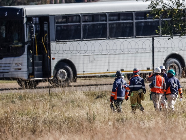 Some of the resurfaced 260 employees stuck underground the South Africa's Sibanye Stillwater's Kloof 7 sub-shaft walk towards a bus in Westonaria on May 23, 2025. Damage to a mine shaft had kept 260 miners stuck in a gold mine outside Johannesburg overnight, the mine manager and union said on May 23, 2025. (Phill Magakoe / AFP via Getty)
