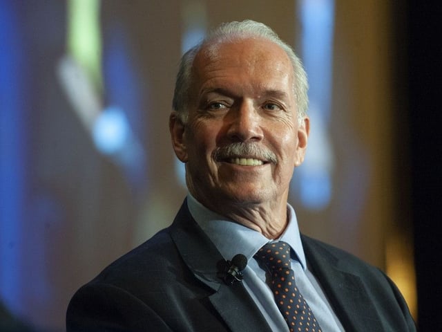 Premier John Horgan, on his last day in office, addresses the B.C. Chamber of Commerce at the Pan Pacific Hotel in Vancouver on Nov. 17, 2022.