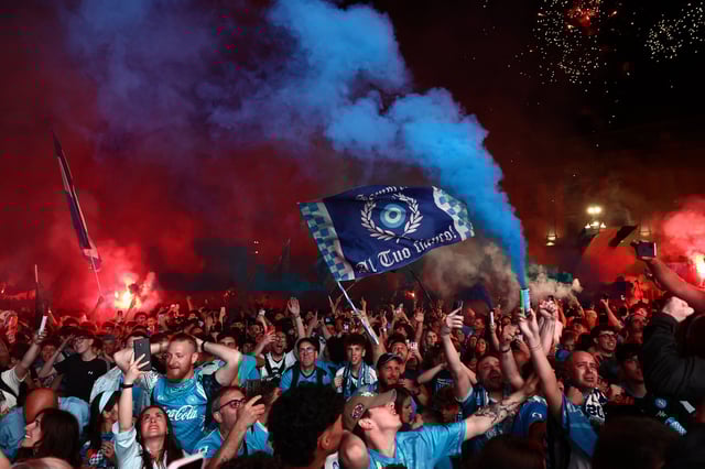 Soccer Football - Serie A - Napoli fans gather to watch Napoli v Cagliari - Naples, Italy - May 23, 2025 Napoli fans celebrate their first goal scored by Scott McTominay as they watch the match in the Piazza del Plebiscito in Naples REUTERS/Yara Nardi