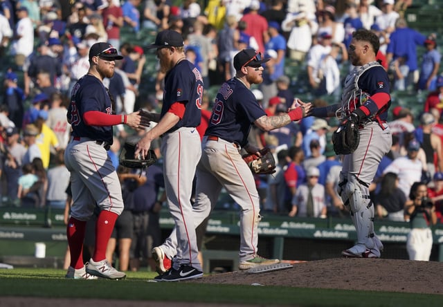 Christian Arroyo #39, Jake Diekman #31, Alex Verdugo #99 and Christian Vazquez #7 of the Boston Red Sox celebrate a 4-2 win over the Chicago Cubs on July 03, 2022 in Chicago.
