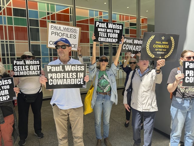 Demonstrators outside the law offices of Paul Weiss in New York on Tuesday, April 22, 2025, are protesting the firm&#39;s agreement to do free legal services for the Trump administration.