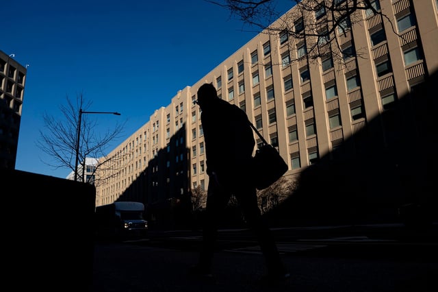A pedestrian near a General Services Administration (GSA) building in Washington, DC, US, on Monday, Feb. 24, 2025.