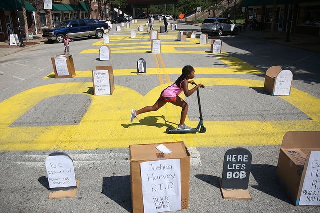 Children play on August 3, 2020, at a Black Lives Matter mural near the site of the Tulsa Race Massacre in Oklahoma.