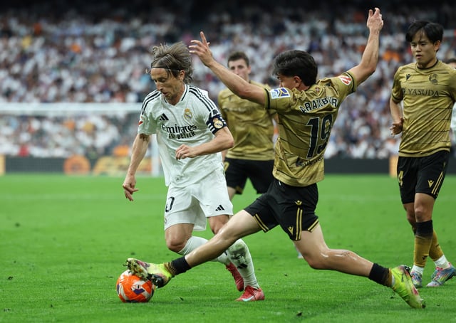 Soccer Football - LaLiga - Real Madrid v Real Sociedad - Santiago Bernabeu, Madrid, Spain - May 24, 2025 Real Madrid's Luka Modric in action with Real Sociedad's Jon Aramburu REUTERS/Isabel Infantes