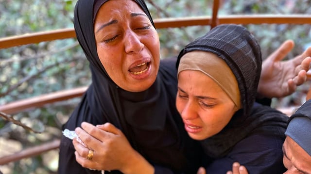 Relatives of Palestinians killed in an Israeli airstrike mourn at Nasser hospital in Khan Younis