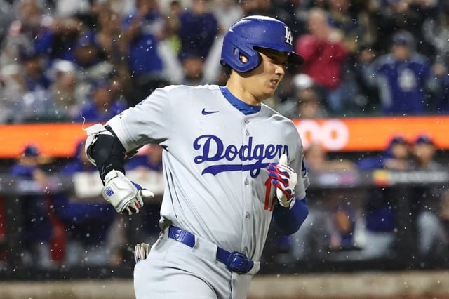 Dodgers’ Shohei Ohtani runs to first base after hitting a single during the ninth inning of a baseball game against the New York Mets, Friday, May 23, 2025, in New York. (AP Photo/Pamela Smith)