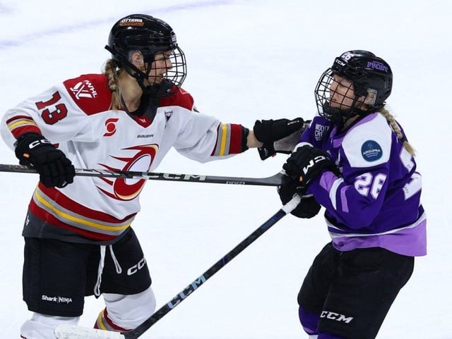 Tereza Vanisová of the Ottawa Charge grabs Kendall Coyne Schofield of the Minnesota Frost during the first overtime period at Xcel Energy Center in St Paul, Minn.,  on May 24, 2025.