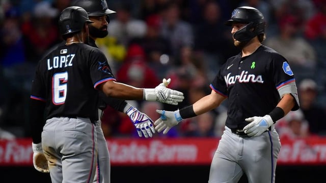 May 24, 2025; Anaheim, California, USA; Miami Marlins third baseman Connor Norby (1) is greeted by shortstop Otto Lopez (6) after hitting a three run home run against the Los Angeles Angels during the seventh inning at Angel Stadium. Mandatory Credit: Gary A. Vasquez-Imagn Images