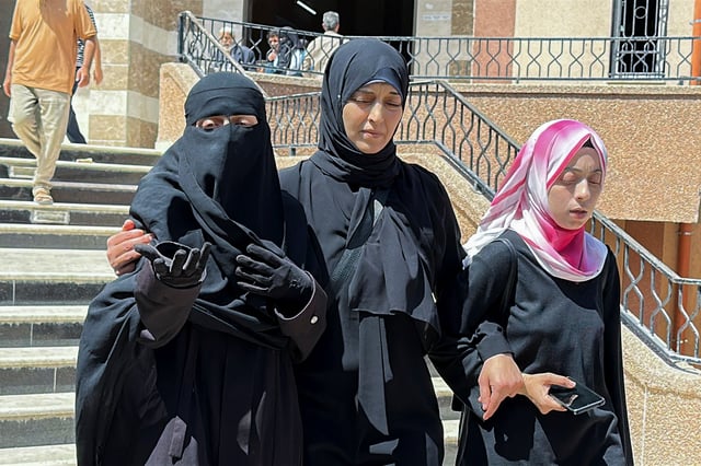 Palestinian Paediatrician Alaa Al-Najjar (L), who lost lost nine of her children in an Israeli strike on Friday, according to medics, reacts at Nassser hospital in Khan Younis, in the southern Gaza Strip, May 25, 2025. REUTERS/Hatem Khaled