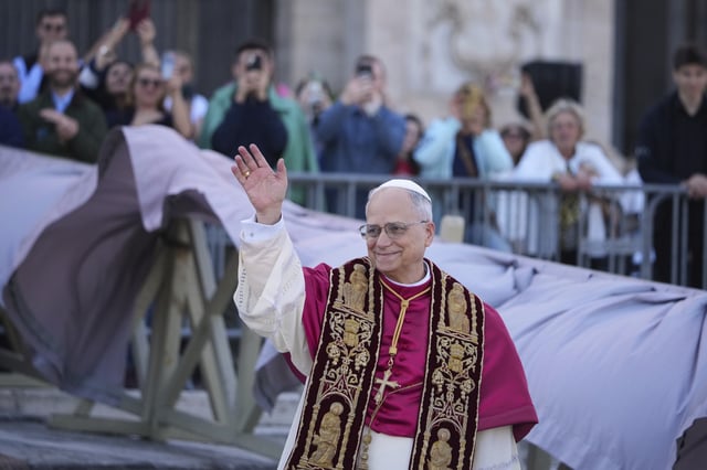 Pope Leo XIV waves upon his arrival at the Arch Basilica of St. John Lateran where he will presides over a Mass and takes possession of the Roman Cathedra, formalising his role as Bishop of Rome, in Rome, Sunday, May 25, 2025. (AP Photo/Andrew Medichini)