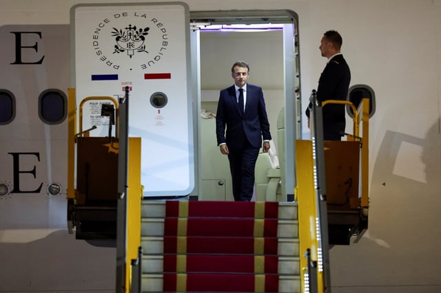France's President Emmanuel Macron walks upon his arrival at Noi Bai International Airport, marking the first trip to Vietnam by a French president in nearly a decade, in Hanoi, Vietnam, May 25, 2025. REUTERS/Chalinee Thirasupa