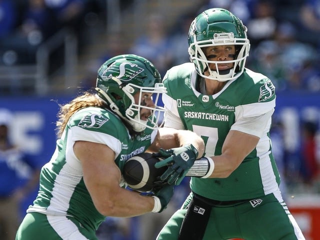 Saskatchewan Roughriders quarterback Trevor Harris (7) hands off to AJ Ouellette (45) during first half preseason CFL football action against the Winnipeg Blue Bombers in Winnipeg, Saturday, May 24, 2025.