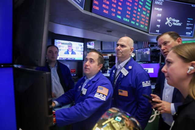 Traders working on the New York Stock Exchange (NYSE) floor during the Hinge Health initial public offering on May 22. 