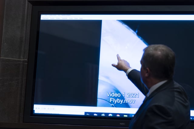 Deputy Director of Naval Intelligence Scott Bray points to a video display of a UAP during a hearing of the House Intelligence, Counterterrorism, Counterintelligence, and Counterproliferation Subcommittee hearing on &#34;Unidentified Aerial Phenomena,&#34; on Capitol Hill, May 17, 2022, in Washington.