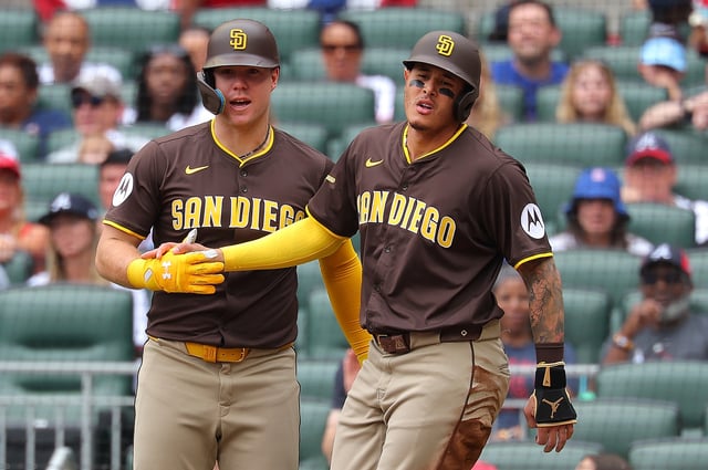 ATLANTA, GEORGIA – MAY 25:  Manny Machado #13 of the San Diego Padres reacts with Gavin Sheets #30 after scoring on a RBI single by Jackson Merrill #3 in the first inning against the Atlanta Braves at Truist Park on May 25, 2025 in Atlanta, Georgia. (Photo by Kevin C. Cox/Getty Images)