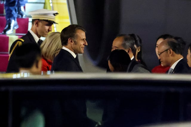 France's President Emmanuel Macron reacts upon his arrival at Noi Bai International Airport, marking the first trip to Vietnam by a French president in nearly a decade, in Hanoi, Vietnam, May 25, 2025. REUTERS/Chalinee Thirasupa
