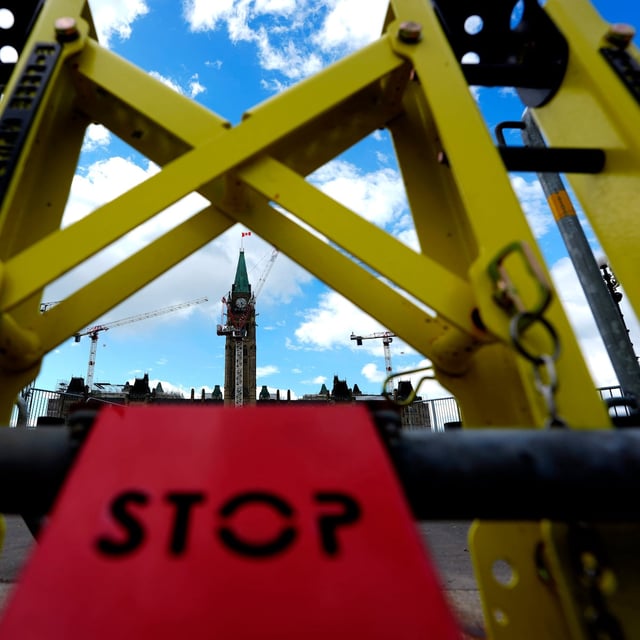 The Peace Tower on Parliament Hill in Ottawa is seen past a temporary gate in the place of the Queen's Gates, which are being restored, ahead of Parliament's Monday return on on Sunday, May 25, 2025. THE CANADIAN PRESS/Justin Tang