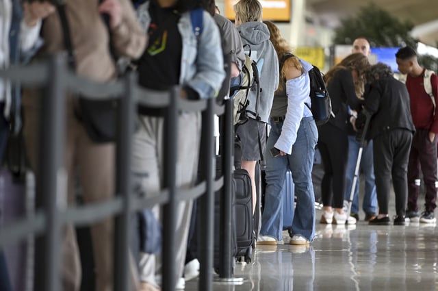 People wait in line at Newark Liberty International Airport&#39;s Terminal B as fewer planes and passengers travel during Memorial Day holidays, May 24, 2025. Passenger traffic was down as demand declined after a series of air traffic disruptions; radar and communications systems were reported to have gone dark and air traffic controllers reported confusion and hazard conditions for flight coming in and going out of the the airport. (Photo by Anthony Behar/Sipa USA)(Sipa via AP Images)