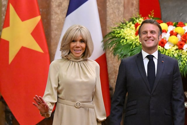 France's President Emmanuel Macron and his wife Brigitte Macron react as they pose for photos during a meeting at the Presidential Palace in Hanoi on May 26, 2025.     NHAC NGUYEN/Pool via REUTERS