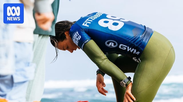 Sally Fitzgibbons bending over after a surfing heat